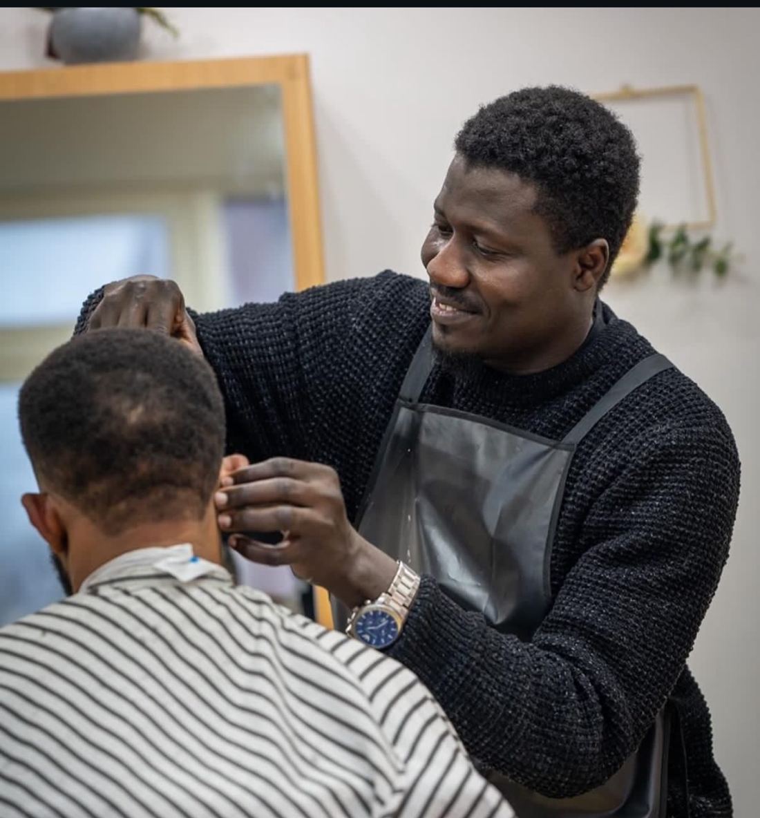 The owner of Precision Fade Studio cutting a client's hair